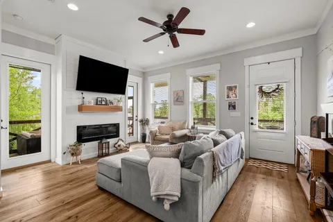 a living room with fireplace furniture and a flat screen tv