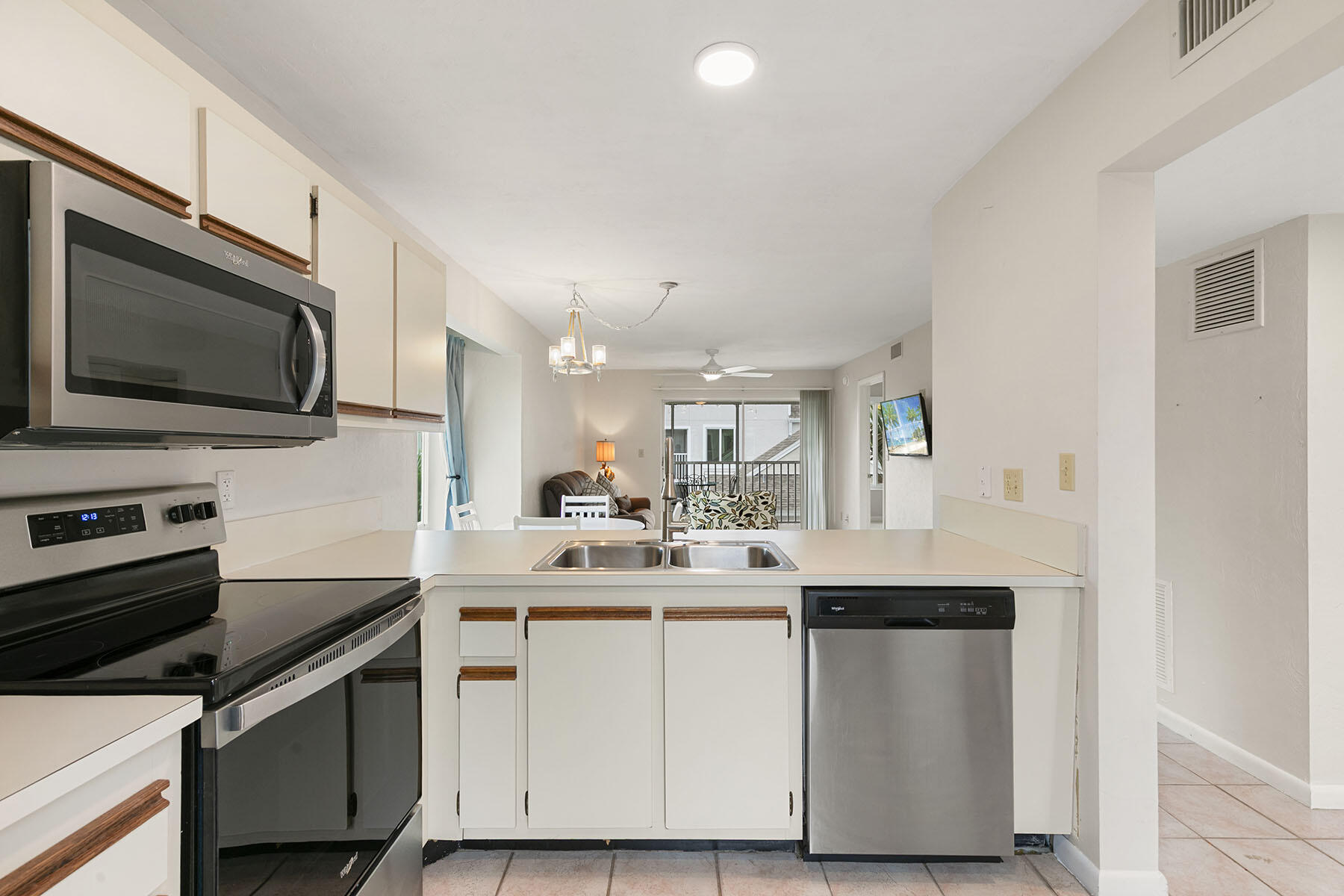 2189 San Marco Road, Unit 201 Marco Island, FL 34145 - Photo 12 of 27 a kitchen with a sink stove and microwave