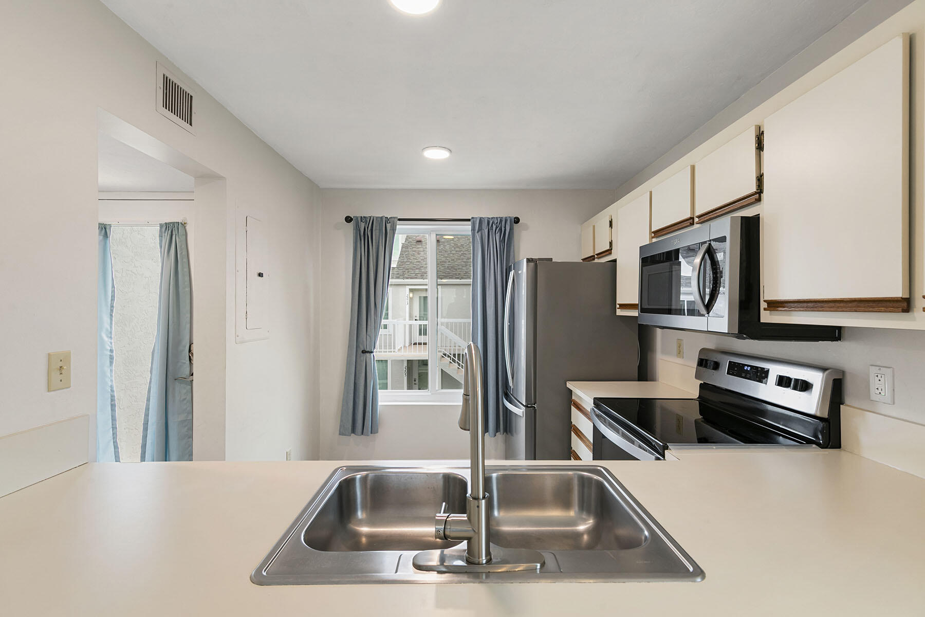 2189 San Marco Road, Unit 201 Marco Island, FL 34145 - Photo 14 of 27 a kitchen with stainless steel appliances a refrigerator a stove a microwave a sink and a refrigerator