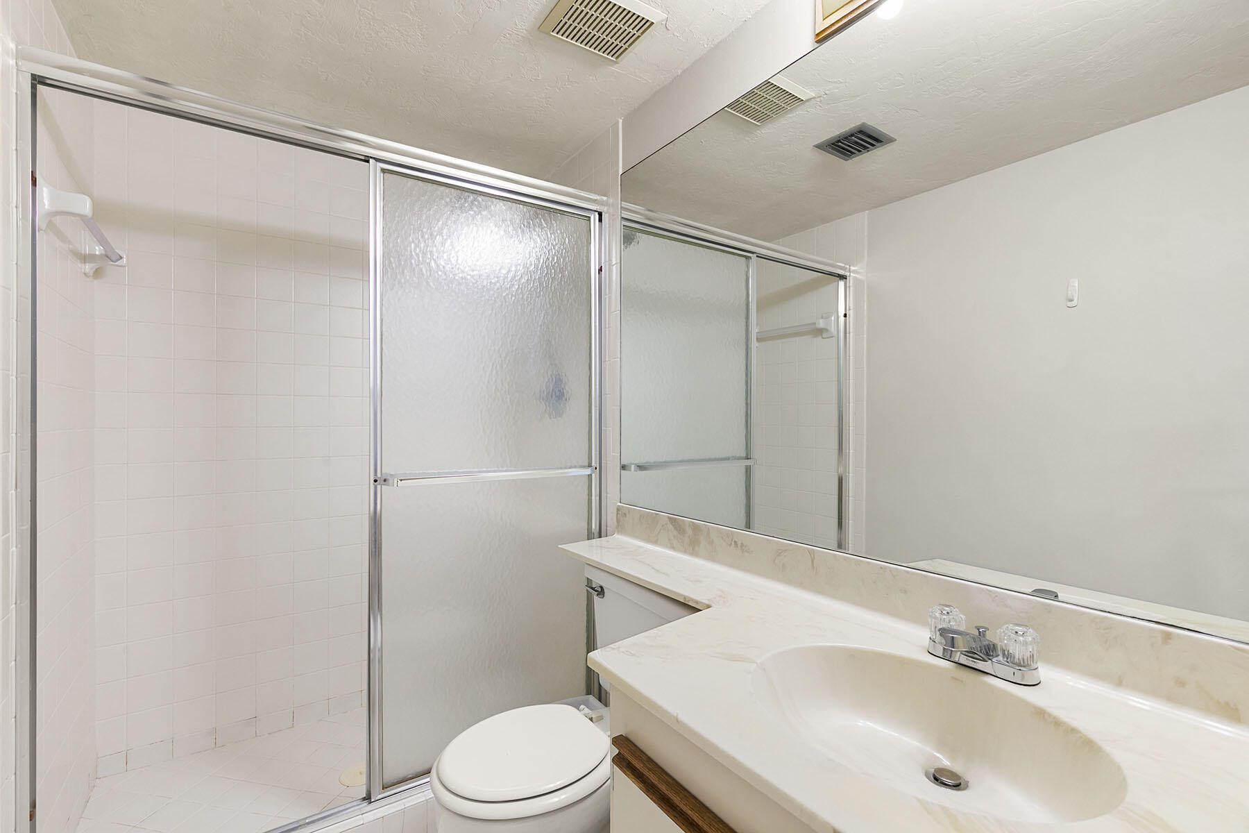 2189 San Marco Road, Unit 201 Marco Island, FL 34145 - Photo 17 of 27 a bathroom with a sink toilet and shower