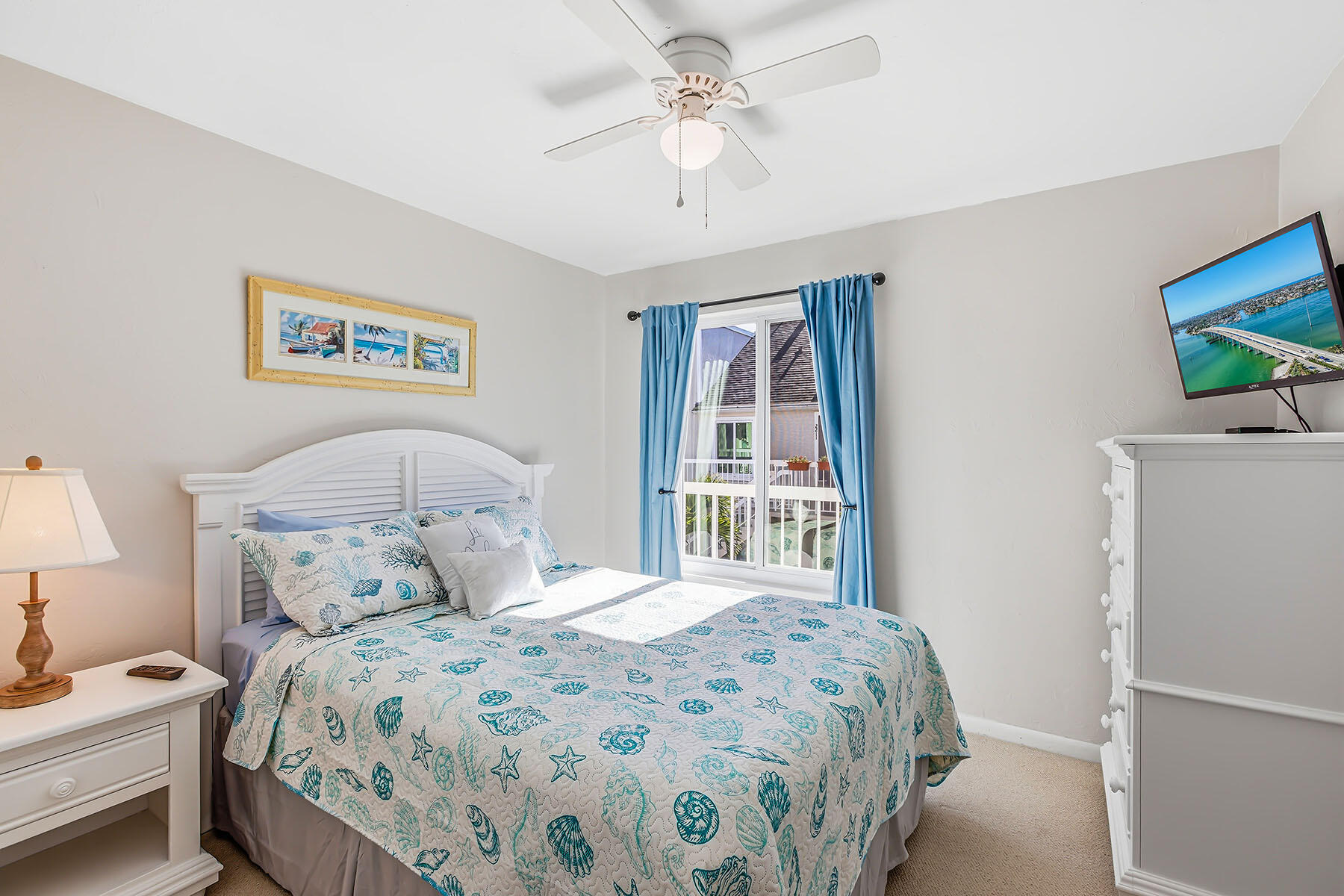 2189 San Marco Road, Unit 201 Marco Island, FL 34145 - Photo 18 of 27 a bedroom with a large bed and a chandelier