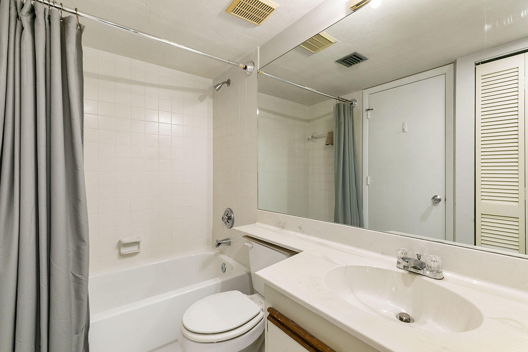 2189 San Marco Road, Unit 201 Marco Island, FL 34145 - Photo 19 of 27 a bathroom with a bathtub shower sink vanity mirror and toilet