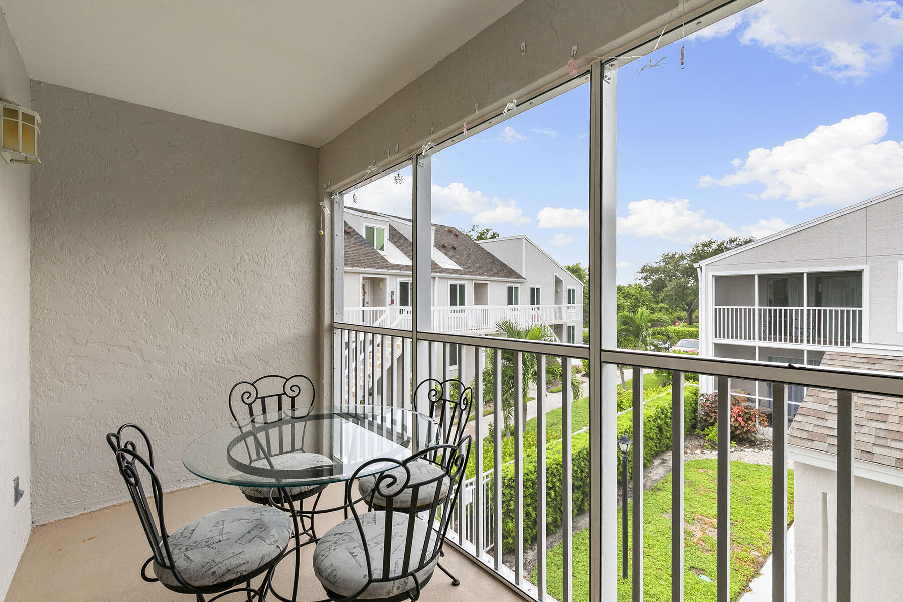 2189 San Marco Road, Unit 201 Marco Island, FL 34145 - Photo 22 of 27 a view of a chair and table in the balcony