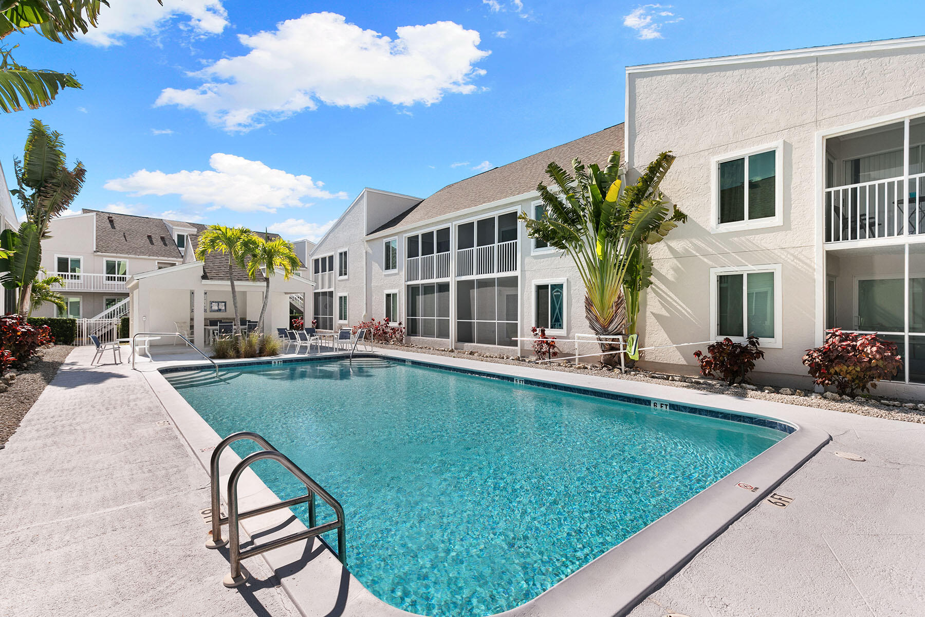 2189 San Marco Road, Unit 201 Marco Island, FL 34145 - Photo 24 of 27 a view of a house with swimming pool and sitting area