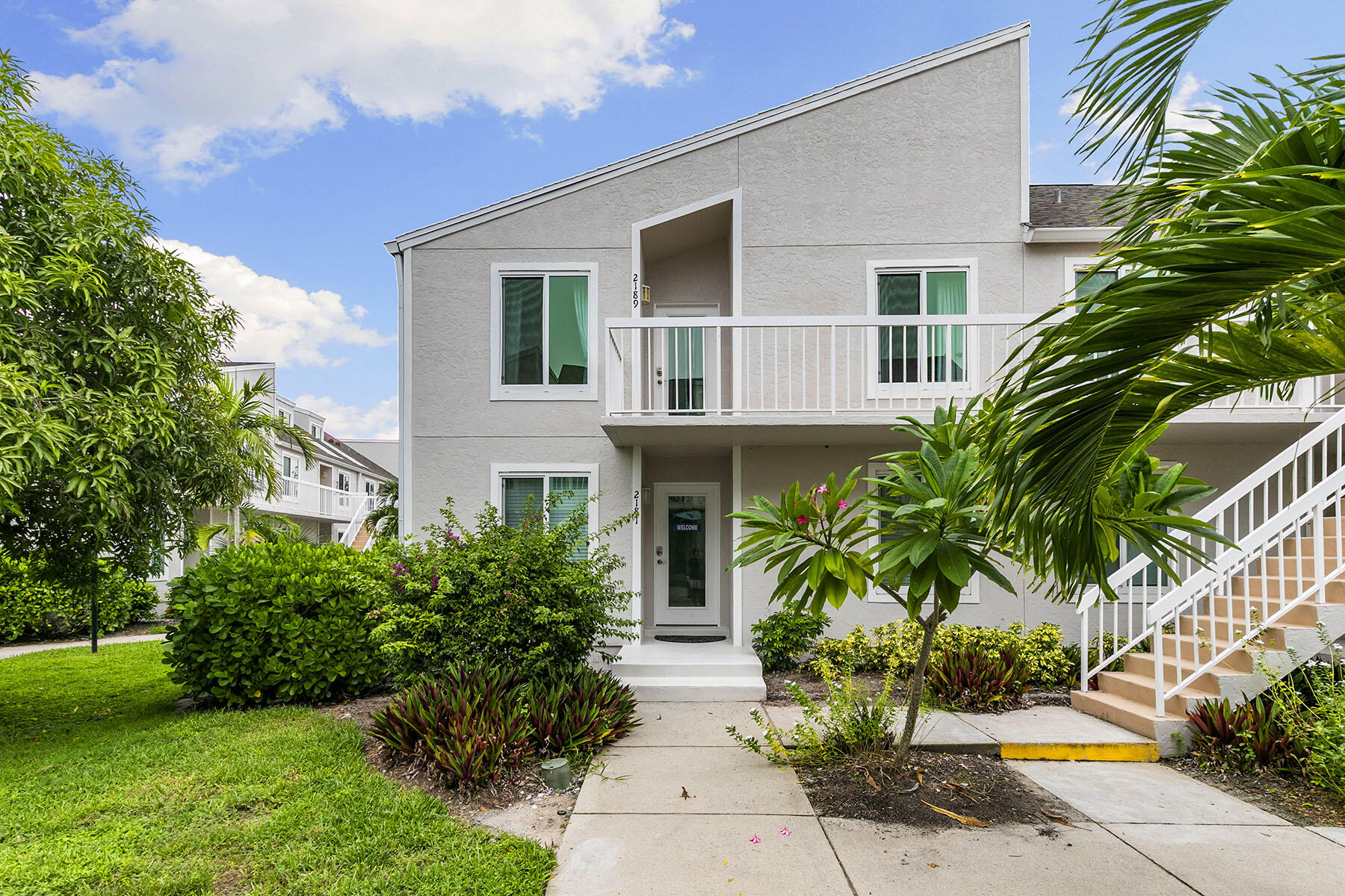 2189 San Marco Road, Unit 201 Marco Island, FL 34145 - Photo 4 of 27 a front view of house with yard and green space