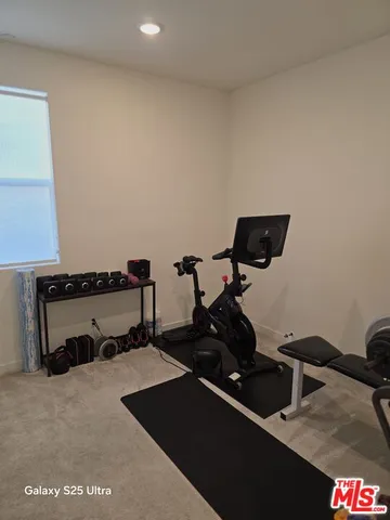 a room with gym equipment and a mirror