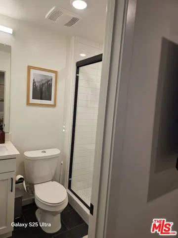 a white toilet sitting next to a small sink