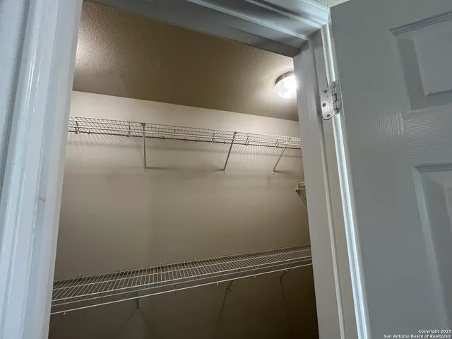 a view of a livingroom with a ceiling fan and wooden floor
