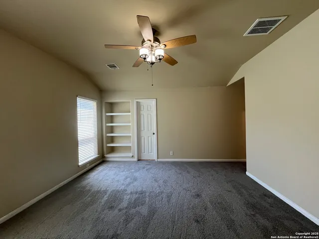 a spacious bathroom with a double vanity sink a large mirror and shower