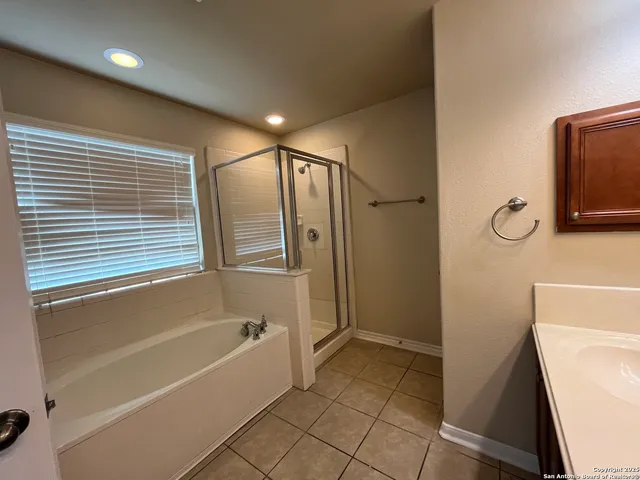 an empty room with a window and a ceiling fan