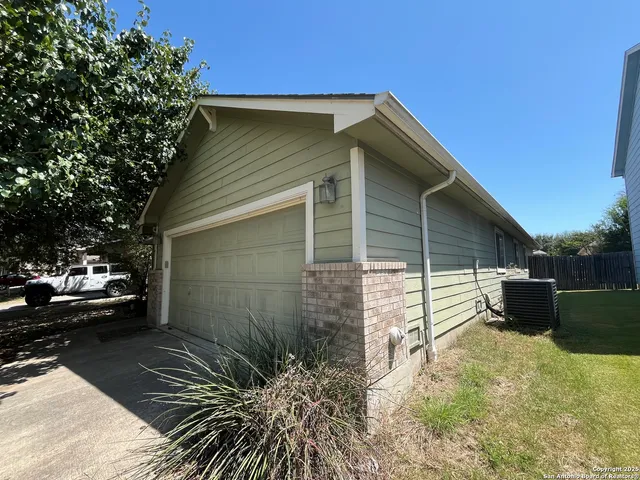 a view of backyard with barbeque grill and potted plants