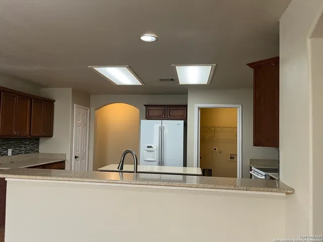 a view of a kitchen with a sink and cabinets