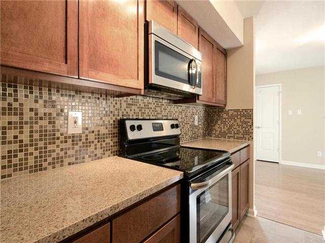 3204 Manchaca Road, Unit 202 Austin, TX 78704 - Photo 1 of 1 a kitchen with granite countertop cabinets stove top oven and microwave