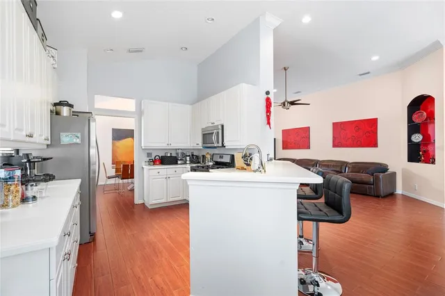 a kitchen that has a lot of cabinets and refrigerator