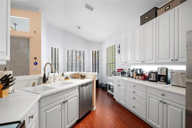 a kitchen with counter top space sink and cabinets