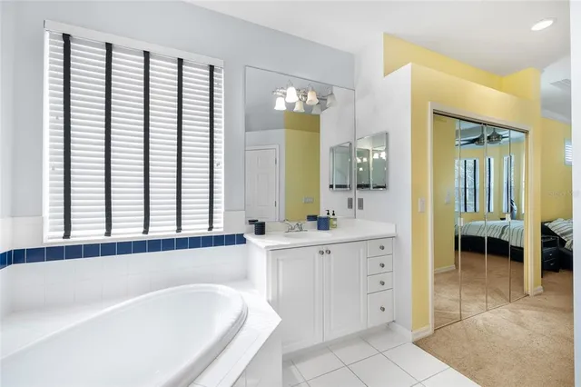 a spacious bathroom with a bathtub and a sink