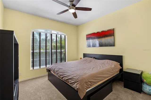 a bedroom with a bed and a painting on the wall