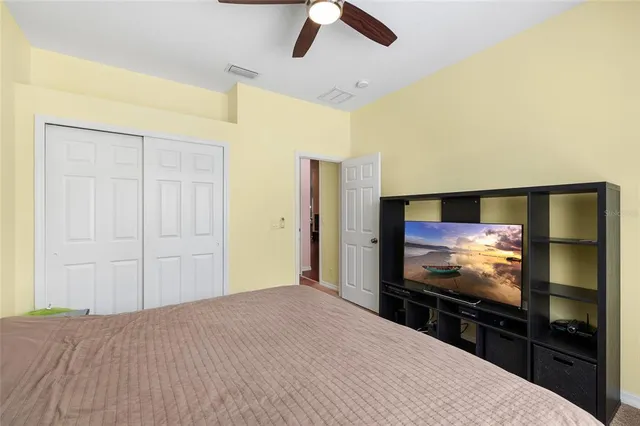 a bedroom with a bed and a flat screen tv