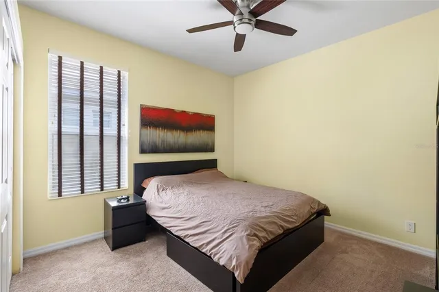 a bedroom with a bed and window