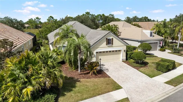 a view of a house with backyard and sitting area