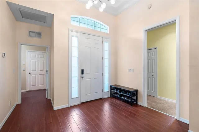 an empty room with wooden floor and closet