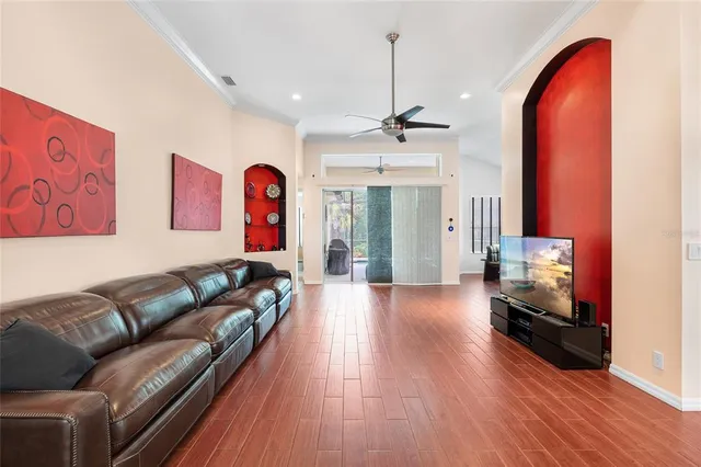 a living room with furniture and wooden floor
