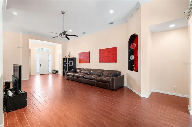 a living room with furniture and a wooden floor
