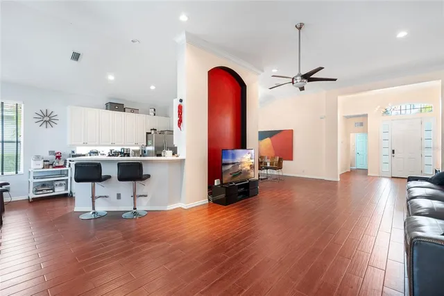a living room with furniture and wooden floor
