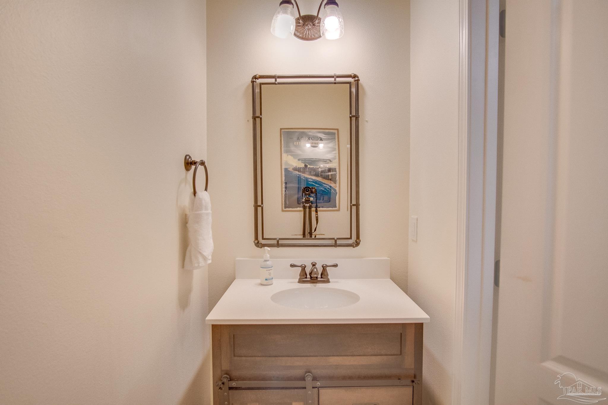 1768 Sound Haven Court Navarre, FL 32566 - Photo 12 of 39 a bathroom with a sink and a mirror