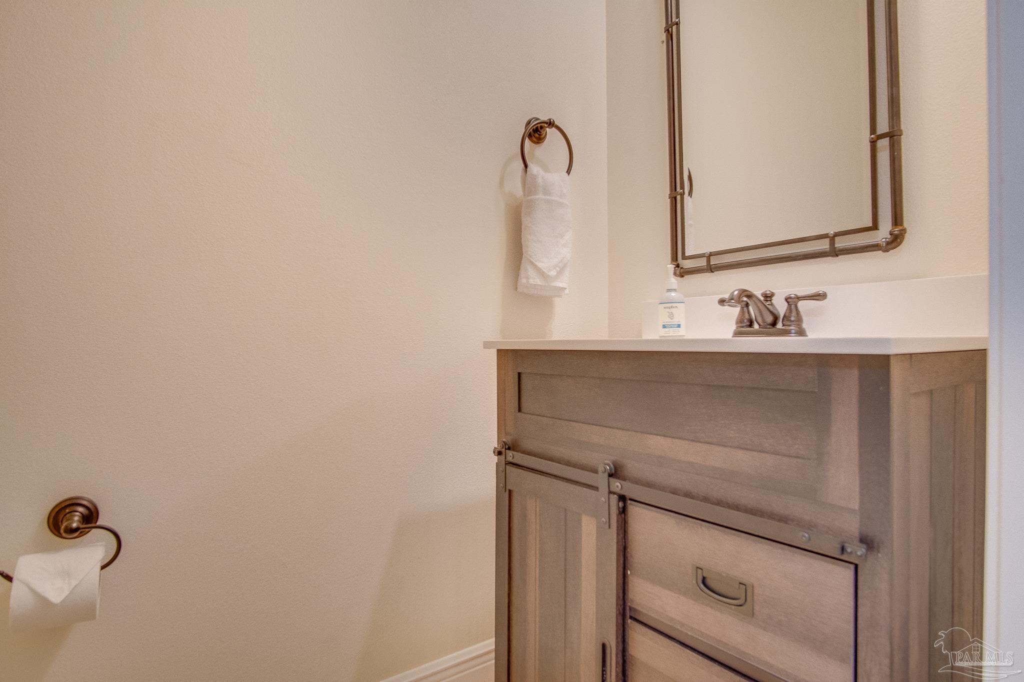 1768 Sound Haven Court Navarre, FL 32566 - Photo 14 of 39 a bathroom with a sink and a mirror