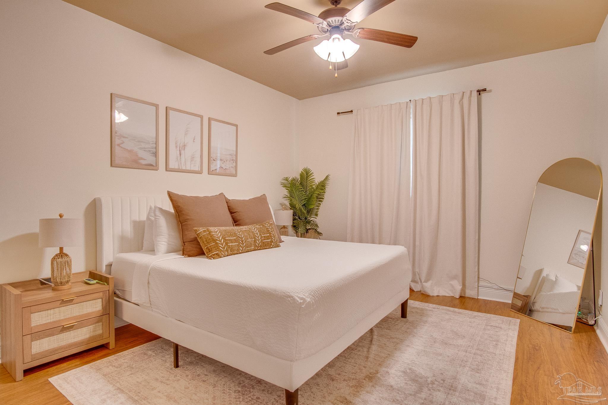 1768 Sound Haven Court Navarre, FL 32566 - Photo 15 of 39 a bedroom with a bed and a chandelier