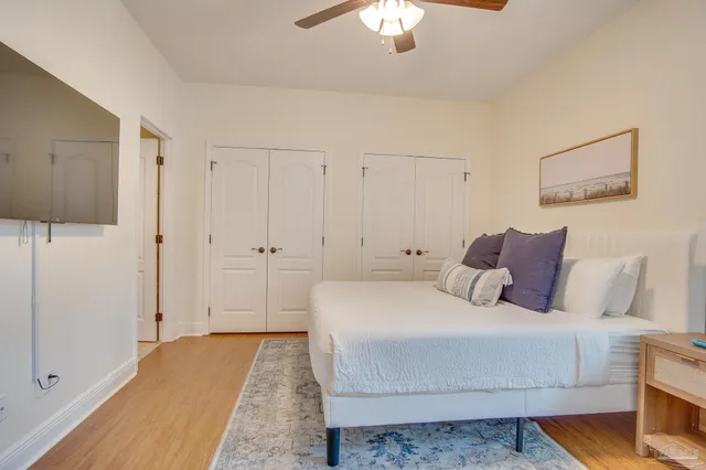 a bedroom with a large bed and a chandelier