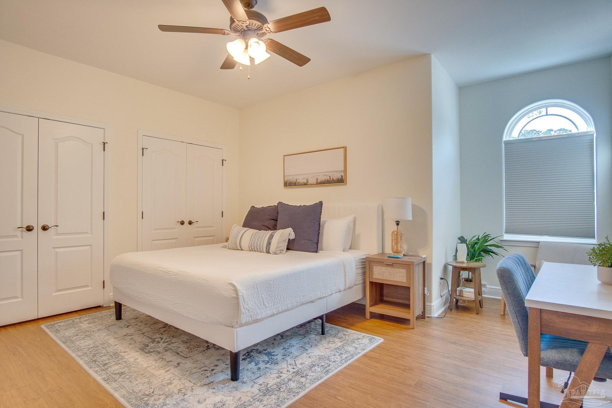 1768 Sound Haven Court Navarre, FL 32566 - Photo 18 of 39 a bedroom with a bed and a chandelier