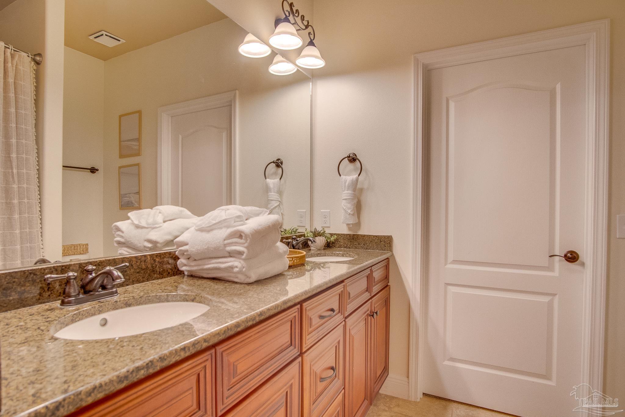 1768 Sound Haven Court Navarre, FL 32566 - Photo 19 of 39 a bathroom with a granite countertop sink and a mirror