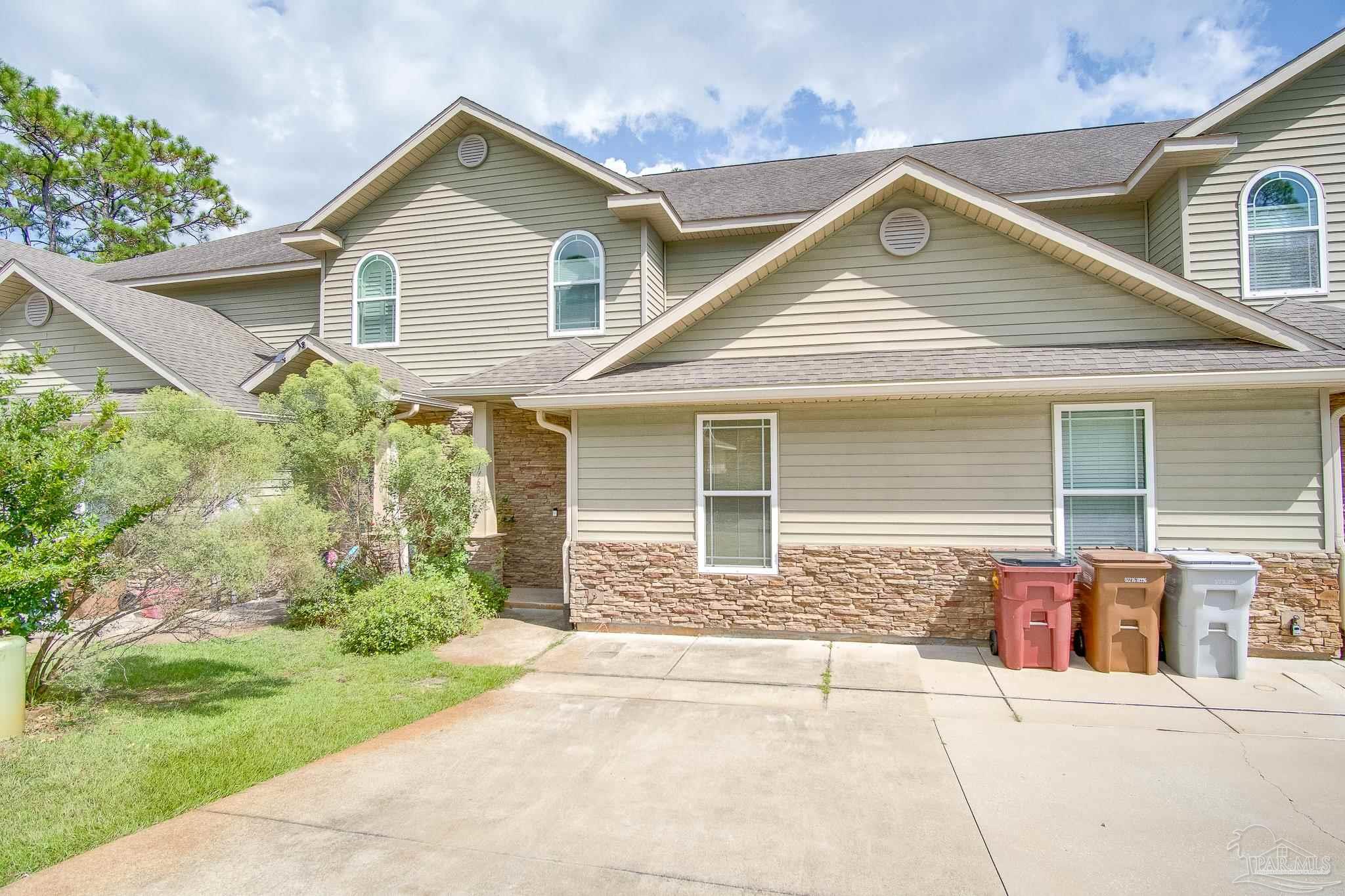 1768 Sound Haven Court Navarre, FL 32566 - Photo 2 of 39 a front view of a house with garden