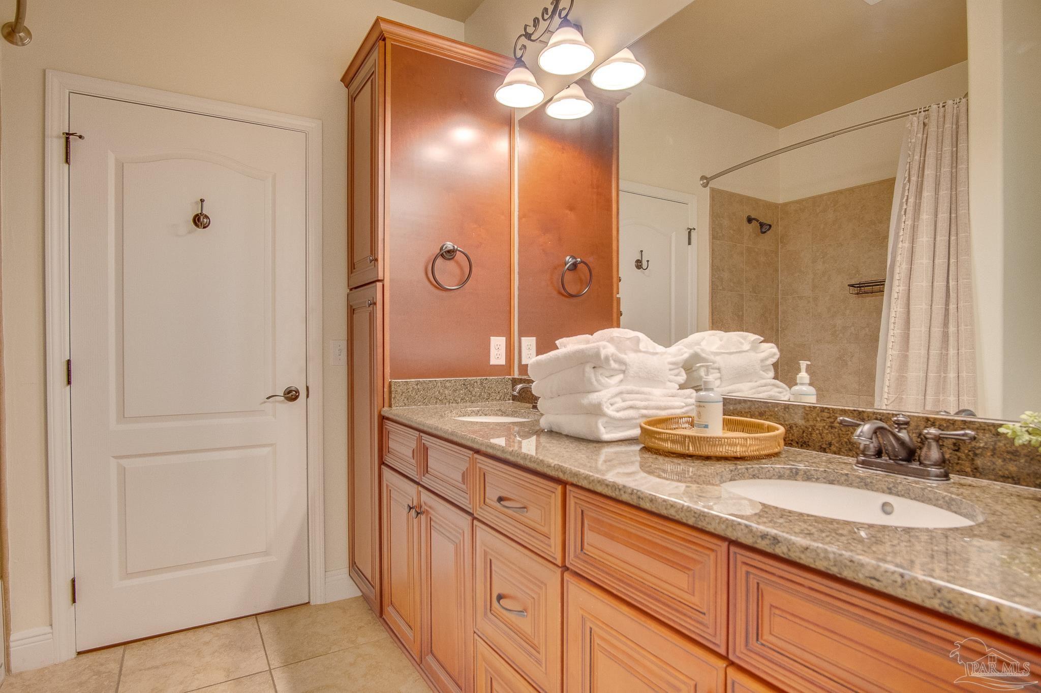 1768 Sound Haven Court Navarre, FL 32566 - Photo 22 of 39 a bathroom with a granite countertop sink and a mirror