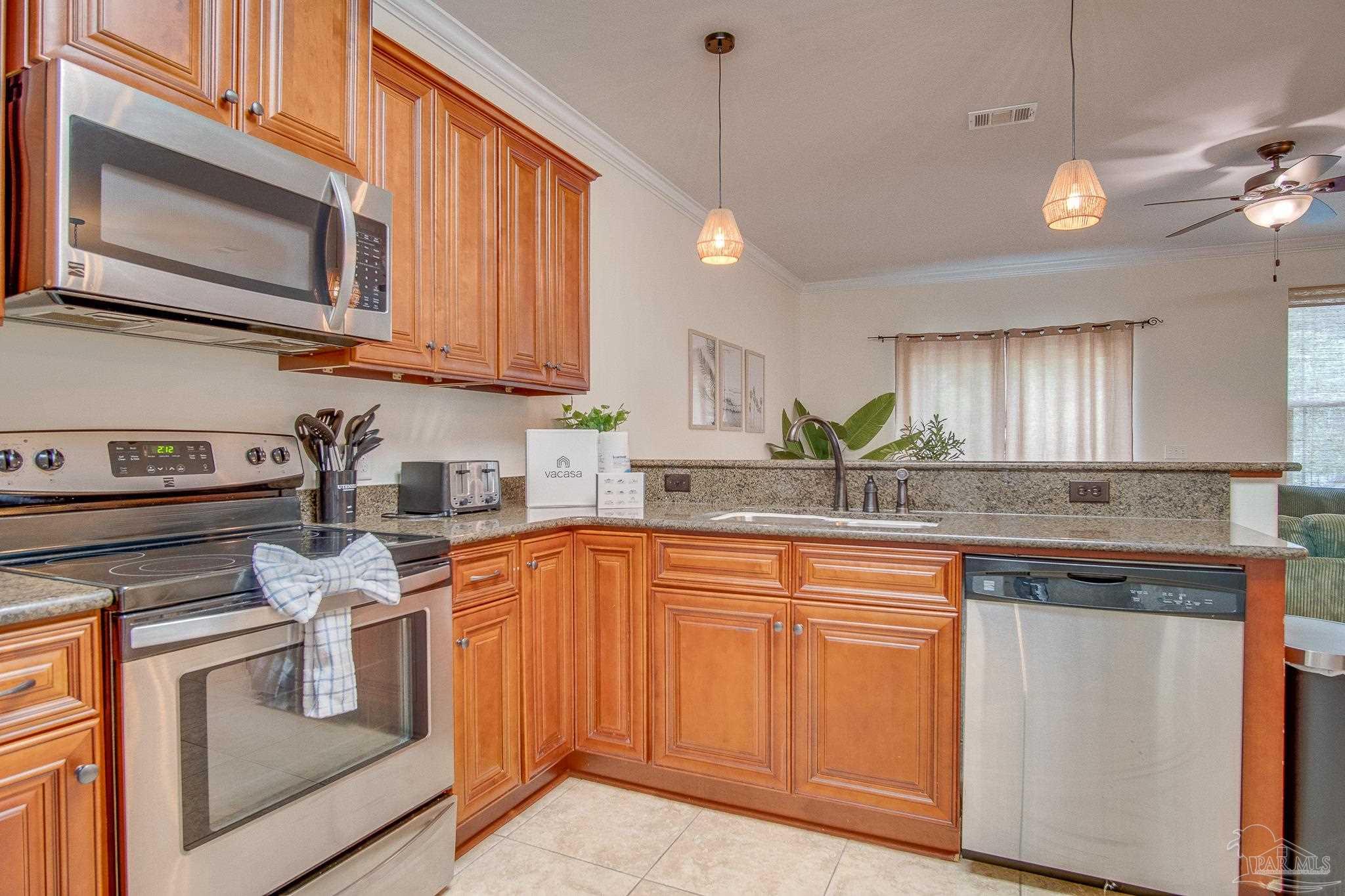 1768 Sound Haven Court Navarre, FL 32566 - Photo 24 of 39 a kitchen with stainless steel appliances granite countertop a sink and cabinets