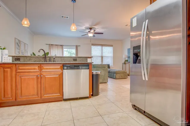 a kitchen with stainless steel appliances granite countertop a refrigerator and microwave