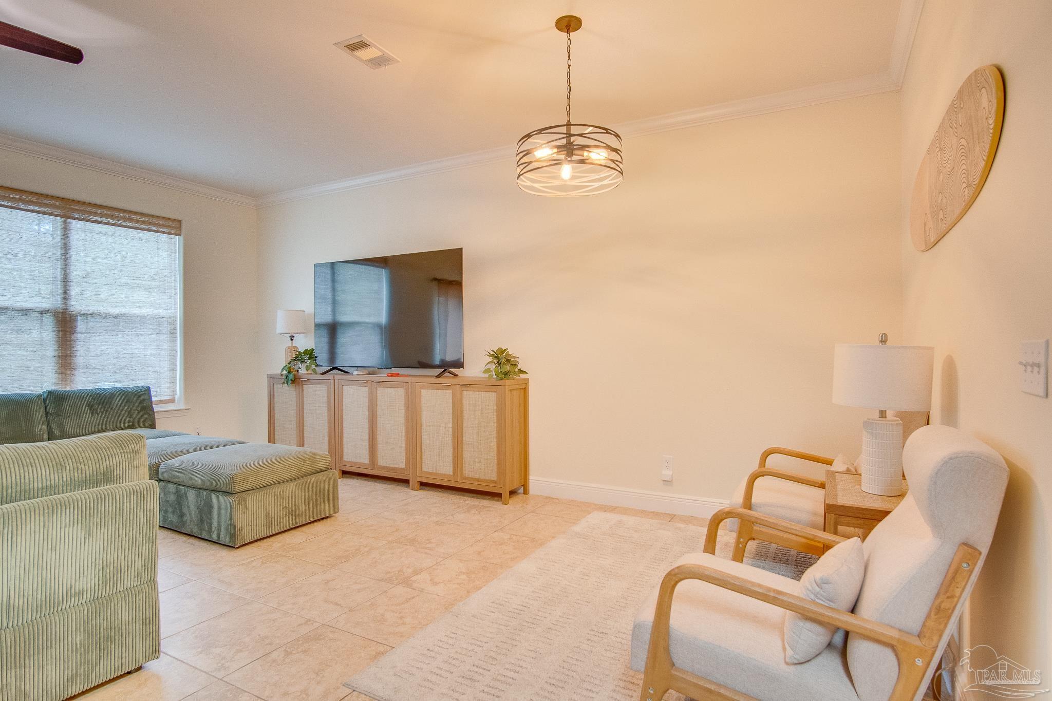 1768 Sound Haven Court Navarre, FL 32566 - Photo 29 of 39 a living room with furniture and a flat screen tv