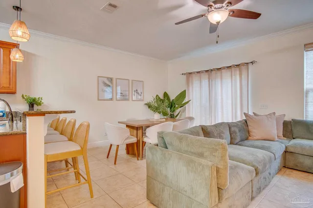 a living room with furniture and a potted plant