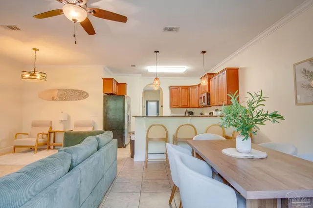 a living room with furniture potted plant and a chandelier