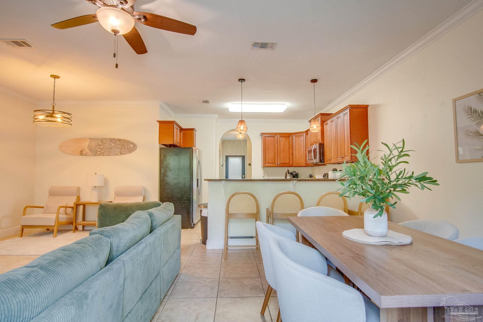 1768 Sound Haven Court Navarre, FL 32566 - Photo 34 of 39 a living room with furniture potted plant and a chandelier