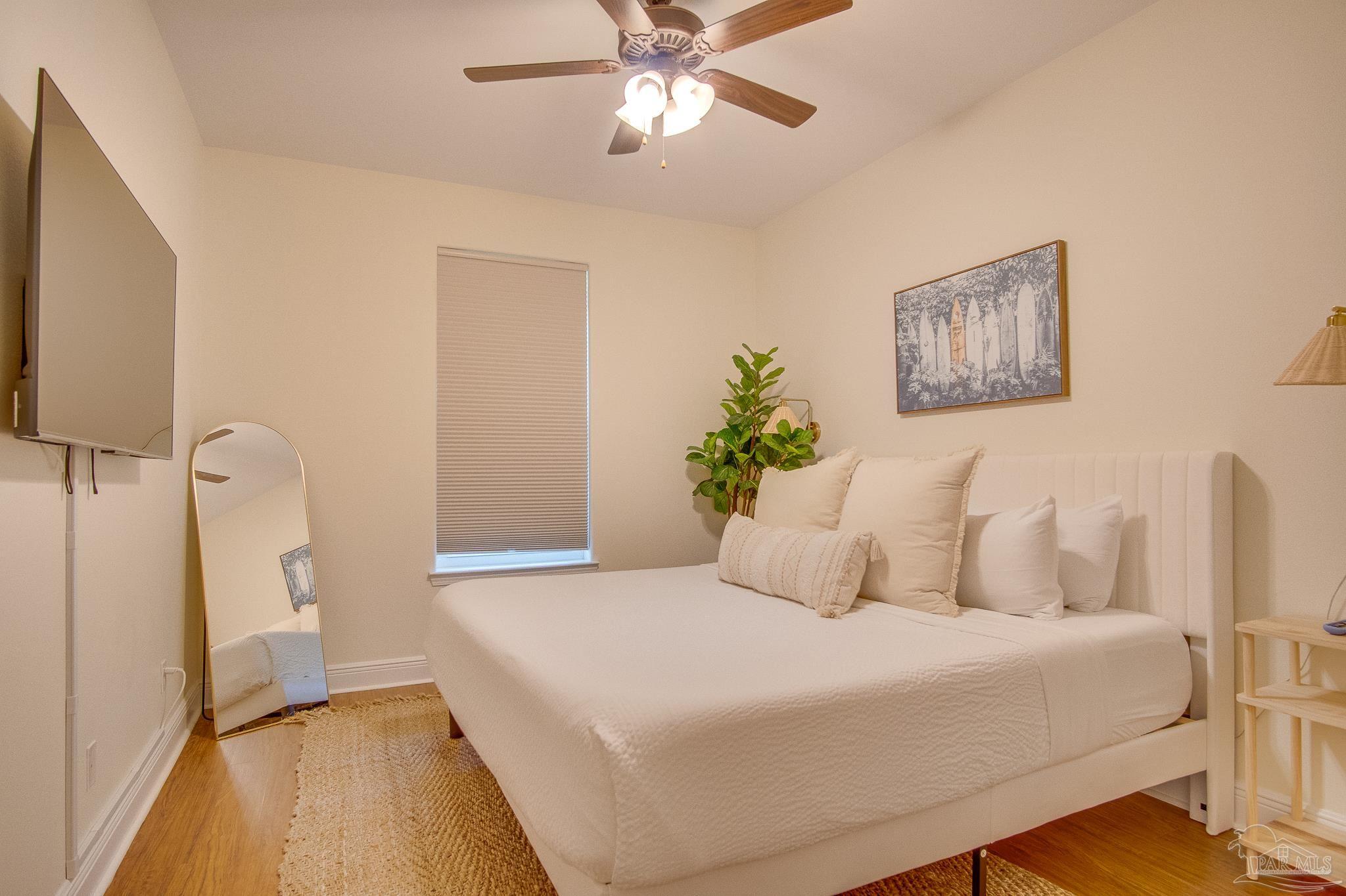 1768 Sound Haven Court Navarre, FL 32566 - Photo 35 of 39 a bedroom with a bed and a ceiling fan