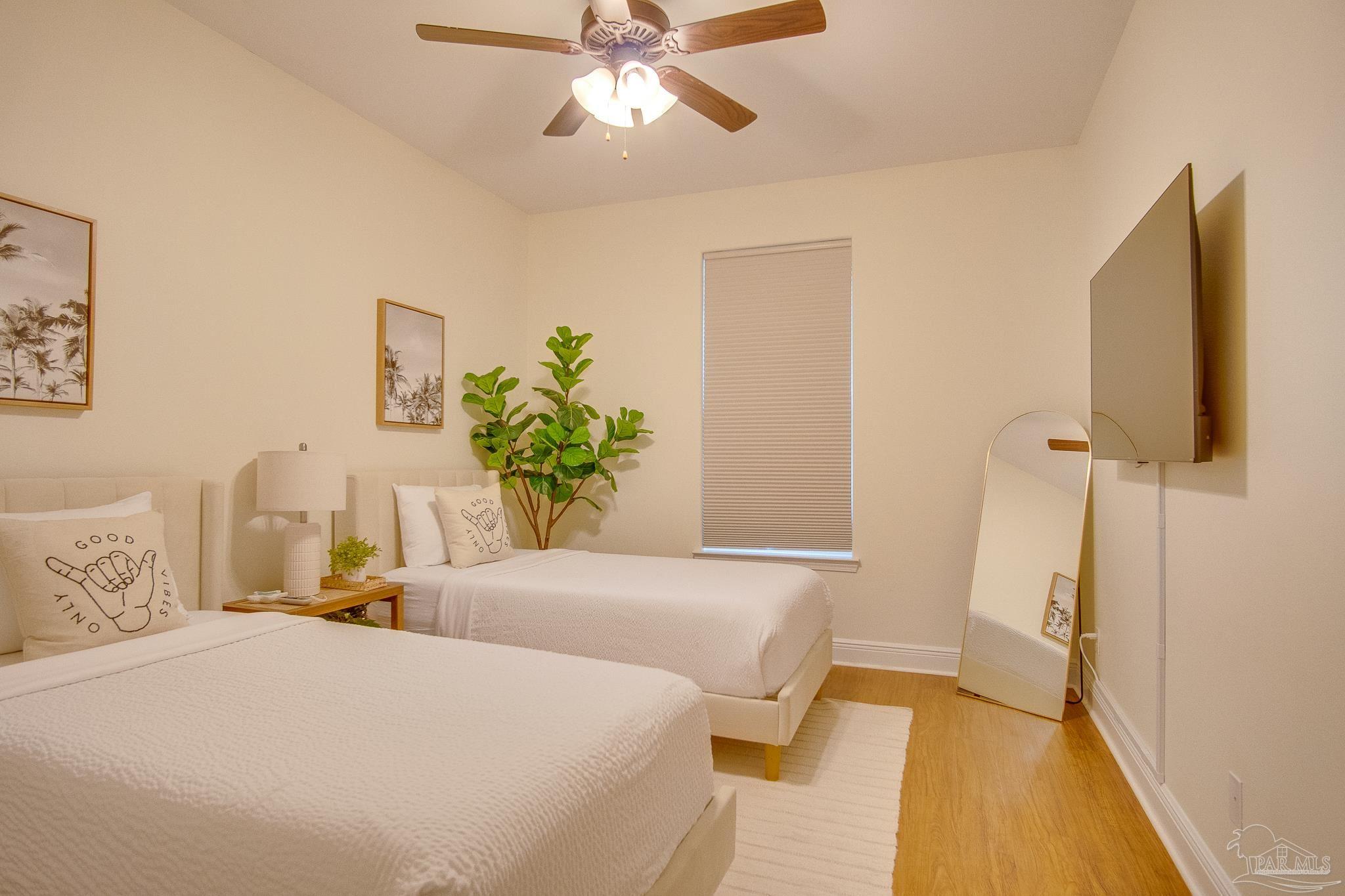 1768 Sound Haven Court Navarre, FL 32566 - Photo 36 of 39 a bedroom with a bed and a chandelier