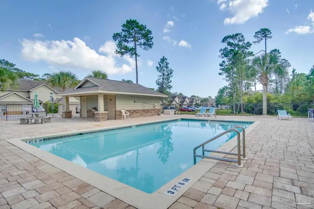 a view of a house with swimming pool and sitting area