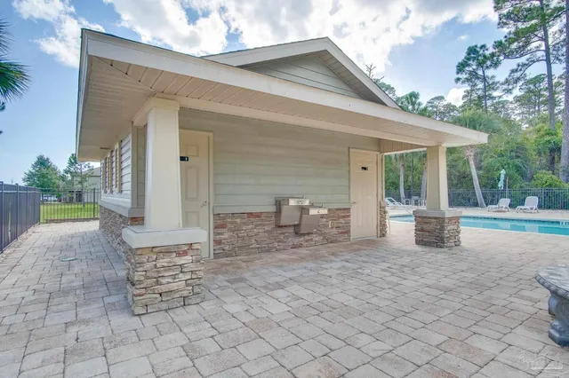 a view of a house with backyard and sitting area