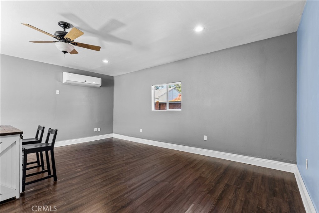 19403 Welby Way Reseda, CA 91335 - Photo 6 of 16 an empty room with wooden floor fan and windows