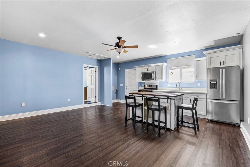 19403 Welby Way Reseda, CA 91335 - Photo 7 of 16 a kitchen with stainless steel appliances a dining table chairs stove and refrigerator