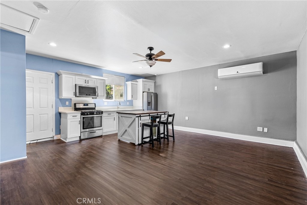 19403 Welby Way Reseda, CA 91335 - Photo 8 of 16 a view of kitchen with sink microwave and cabinets