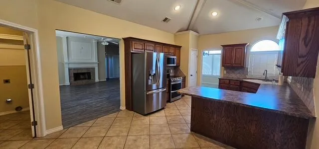a kitchen with stainless steel appliances a refrigerator and cabinets